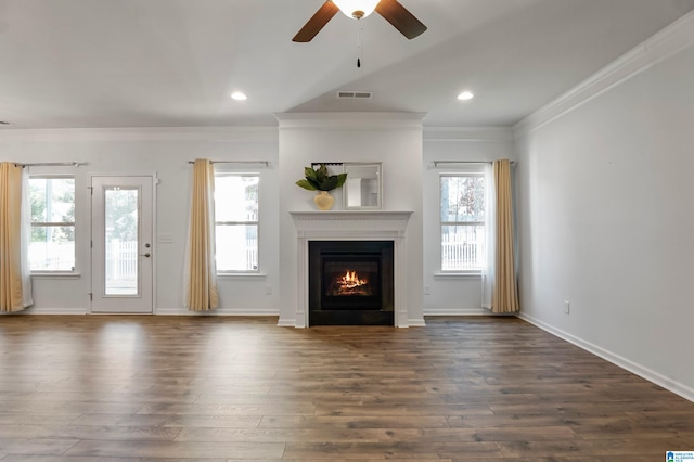 unfurnished living room featuring a wealth of natural light, ceiling fan, dark hardwood / wood-style floors, and ornamental molding