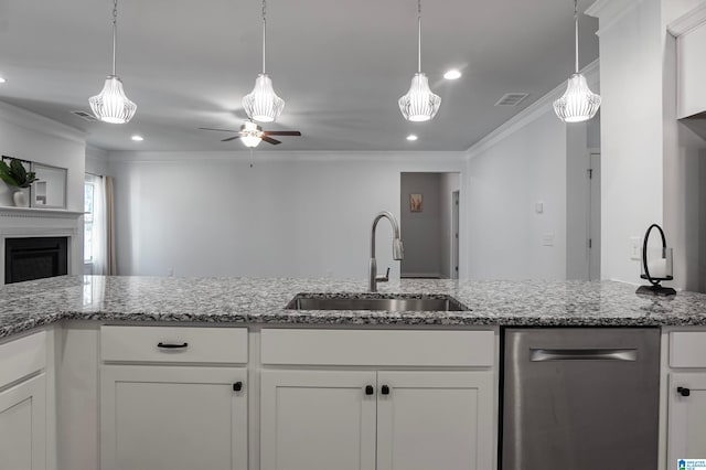 kitchen featuring ceiling fan, crown molding, white cabinetry, and sink