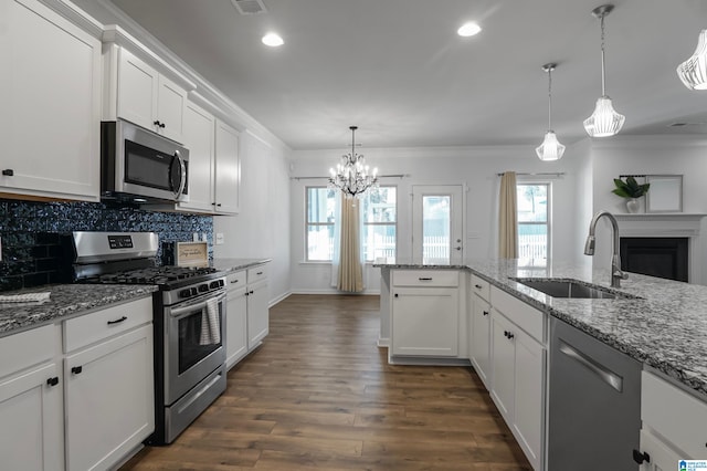 kitchen featuring white cabinets, stainless steel appliances, dark wood-type flooring, and sink