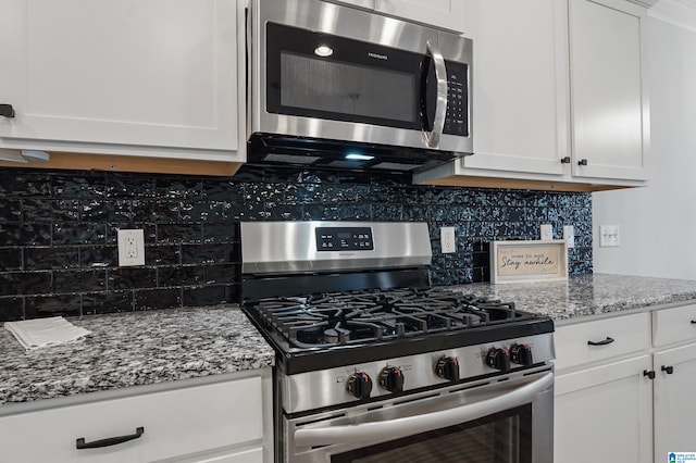 kitchen featuring light stone countertops, appliances with stainless steel finishes, backsplash, and white cabinetry