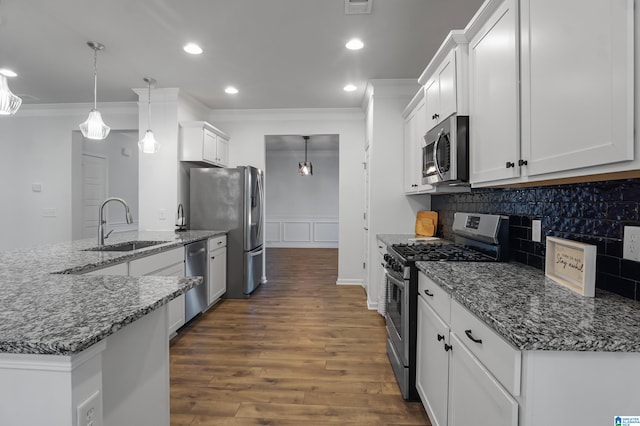 kitchen featuring white cabinetry, hanging light fixtures, stainless steel appliances, and dark hardwood / wood-style floors