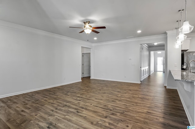 unfurnished living room featuring ceiling fan, crown molding, and dark wood-type flooring