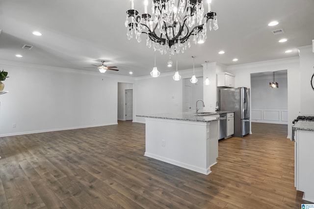 kitchen with sink, dark hardwood / wood-style flooring, stainless steel refrigerator with ice dispenser, decorative light fixtures, and white cabinets