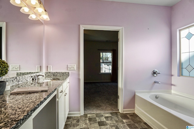 bathroom with a washtub and vanity