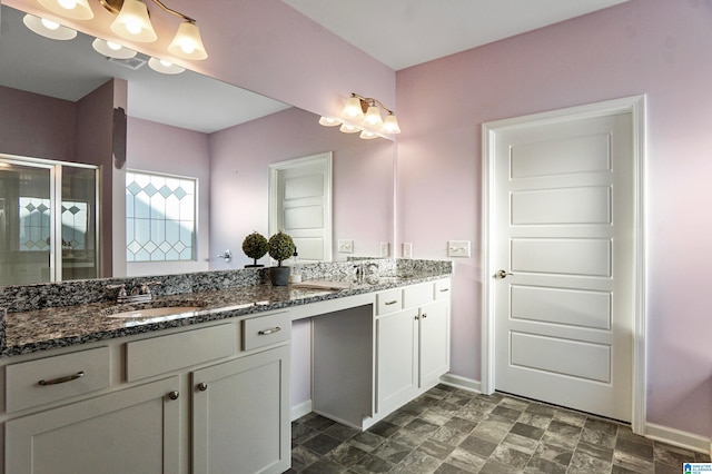 bathroom featuring vanity and a shower with shower door