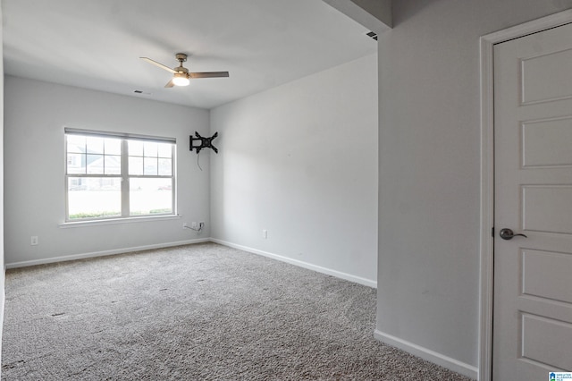 unfurnished room featuring ceiling fan and carpet