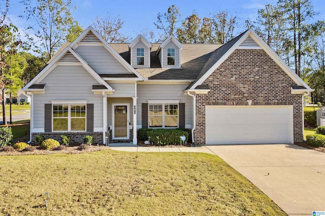 view of front of house with a front yard and a garage