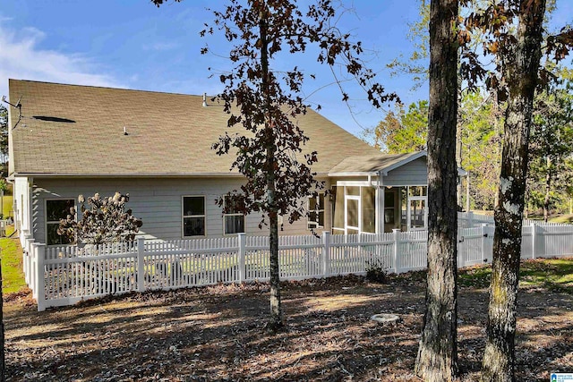 rear view of property with a sunroom