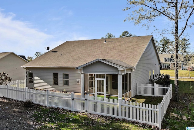 rear view of property with a sunroom