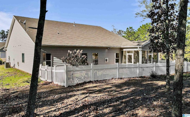 rear view of house with cooling unit and a sunroom