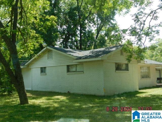 view of home's exterior with a yard