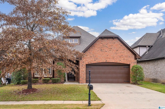 view of front of home with a front yard and a garage