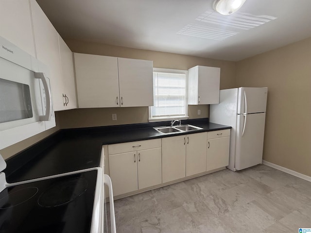 kitchen featuring white appliances, white cabinetry, and sink