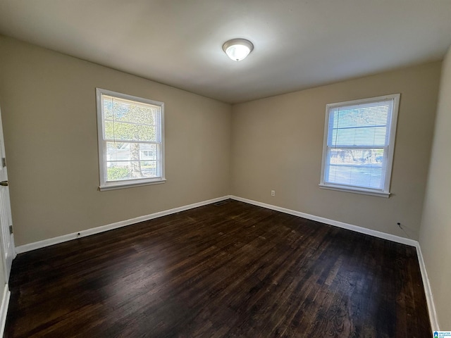 unfurnished room featuring dark wood-type flooring