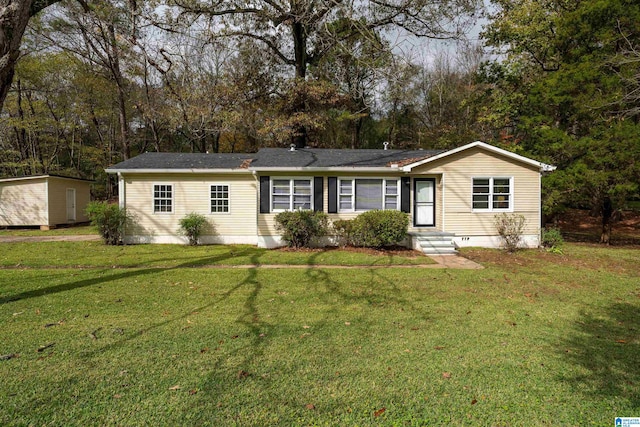 ranch-style home featuring a shed and a front yard