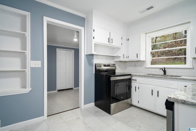 kitchen featuring stainless steel electric stove, white cabinetry, sink, and light stone countertops