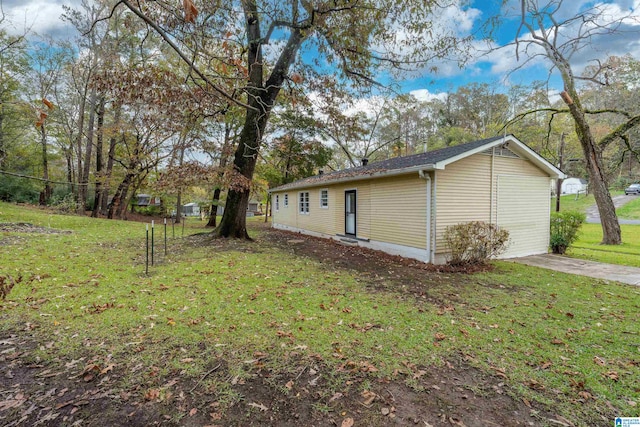 view of side of home with a yard