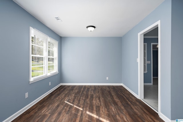 spare room with dark hardwood / wood-style floors