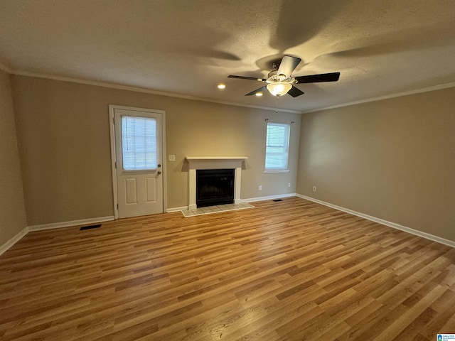 5807 Woodgate Cir, Anniston, AL 36207 - unfurnished living room with crown molding, wood finished floors, baseboards, a fireplace, and a textured ceiling