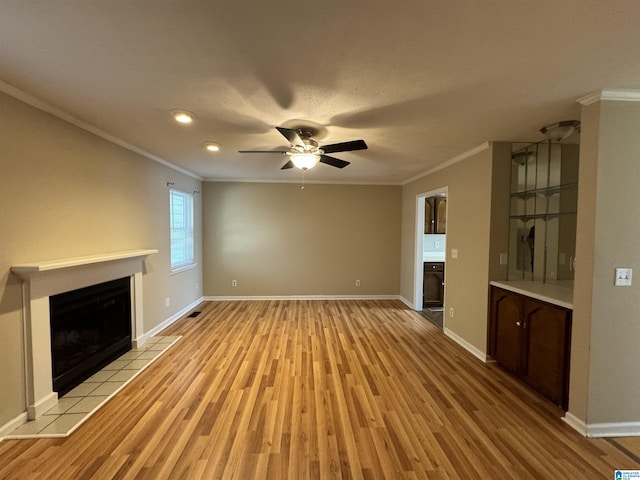5807 Woodgate Cir, Anniston, AL 36207 - unfurnished living room featuring ornamental molding, light wood-style flooring, a fireplace, baseboards, and a ceiling fan