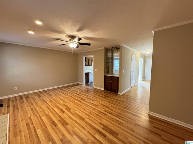 5807 Woodgate Cir, Anniston, AL 36207 - unfurnished living room featuring ornamental molding, light wood-style floors, baseboards, ceiling fan, and recessed lighting