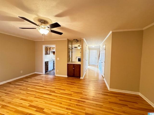 unfurnished living room with ceiling fan, light hardwood / wood-style flooring, a textured ceiling, and ornamental molding