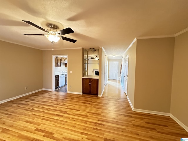 5807 Woodgate Cir, Anniston, AL 36207 - unfurnished living room with a ceiling fan, ornamental molding, light wood-type flooring, baseboards, and a sink