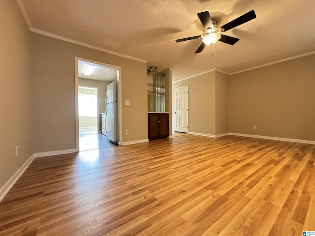 5807 Woodgate Cir, Anniston, AL 36207 - unfurnished room featuring light wood-type flooring, ornamental molding, ceiling fan, and baseboards
