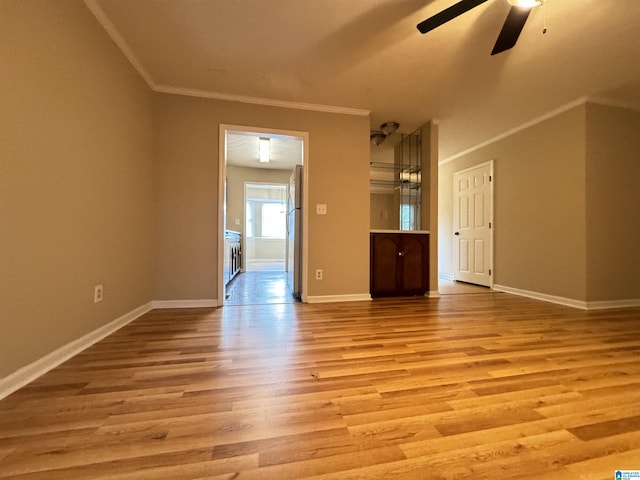 5807 Woodgate Cir, Anniston, AL 36207 - unfurnished living room featuring ceiling fan, light wood-type flooring, baseboards, and crown molding