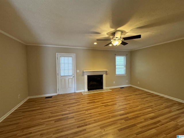 5807 Woodgate Cir, Anniston, AL 36207 - unfurnished living room featuring wood finished floors, a fireplace, a ceiling fan, baseboards, and ornamental molding