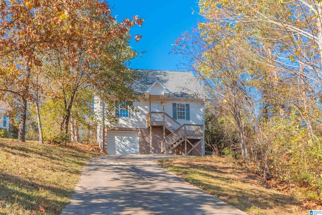 view of front of house with a garage and a front lawn