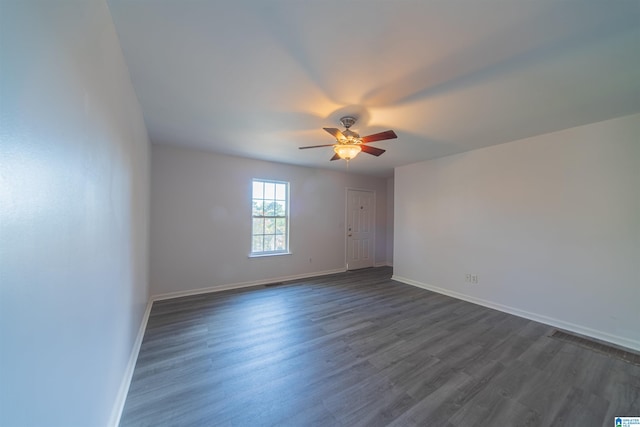 empty room featuring dark hardwood / wood-style floors and ceiling fan