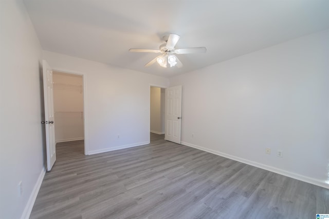 spare room with light hardwood / wood-style floors and ceiling fan