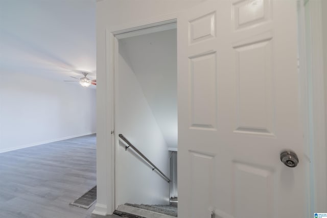 stairs with ceiling fan and wood-type flooring