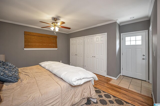 bedroom with hardwood / wood-style floors, ceiling fan, and crown molding