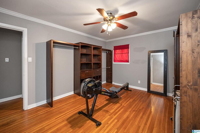 exercise area with hardwood / wood-style floors, ceiling fan, and ornamental molding