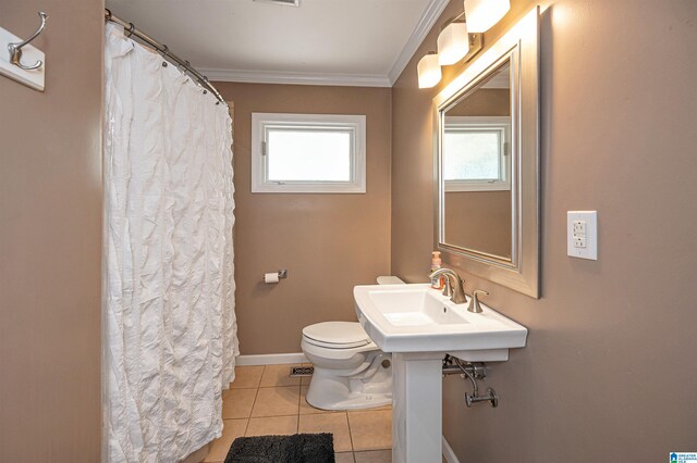 bathroom with crown molding, tile patterned flooring, and toilet