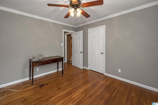 empty room with ceiling fan, dark hardwood / wood-style floors, and ornamental molding