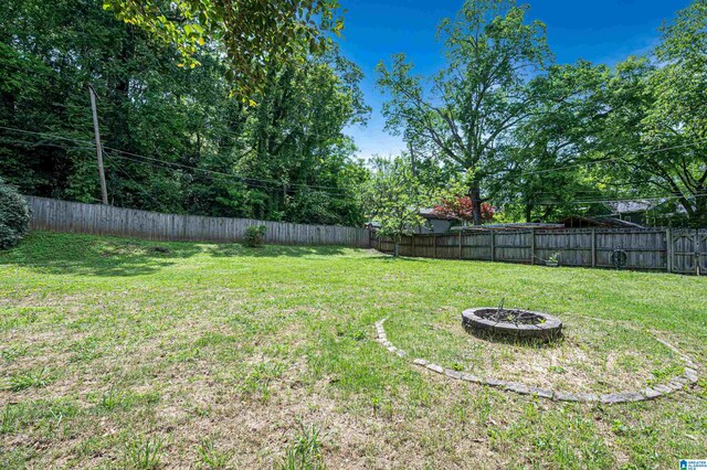 view of yard with a fire pit