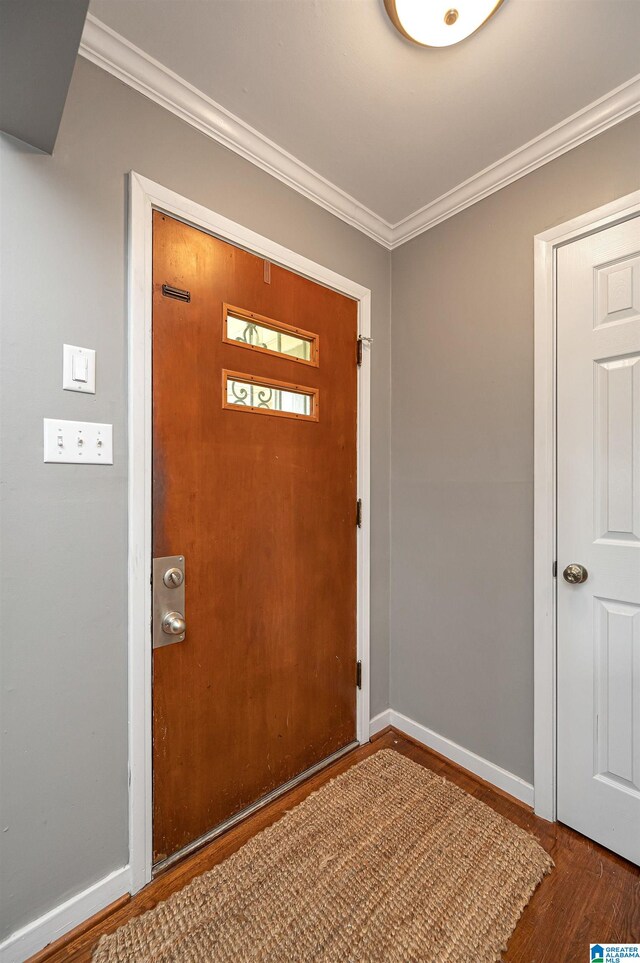 foyer featuring hardwood / wood-style floors and crown molding