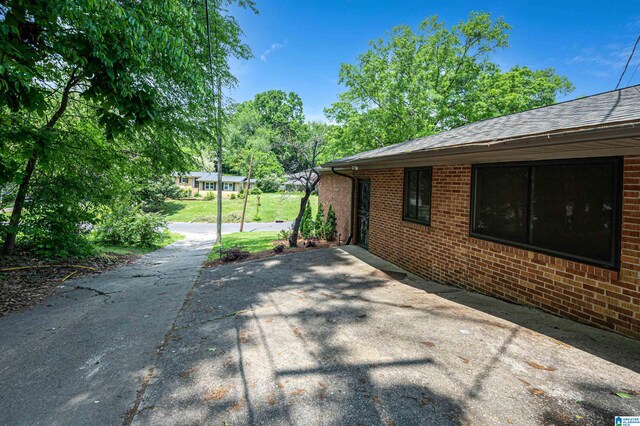 view of side of property featuring a patio area