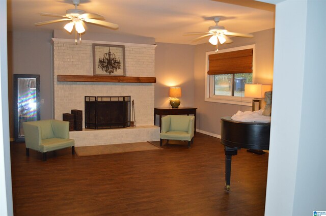 interior space with ceiling fan, a fireplace, and dark wood-type flooring