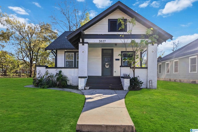 bungalow featuring a porch and a front yard