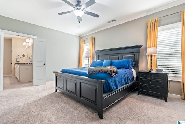 carpeted bedroom featuring connected bathroom, ceiling fan, and ornamental molding