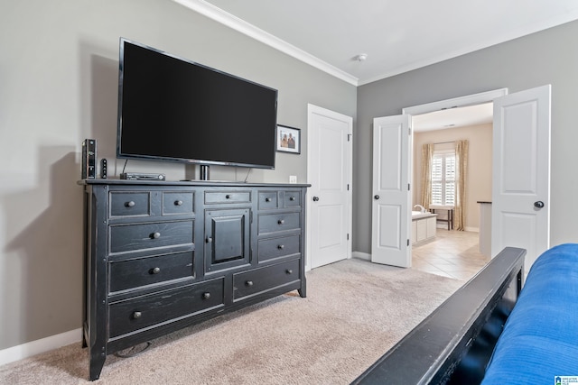 carpeted bedroom featuring ensuite bathroom and crown molding