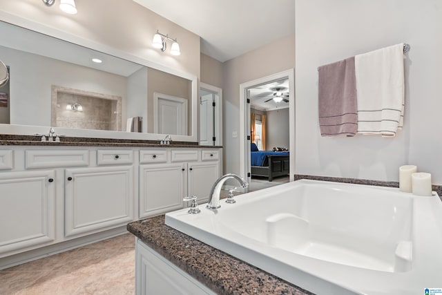 bathroom with tile patterned flooring, vanity, a tub to relax in, and ceiling fan