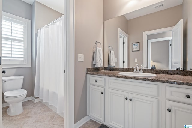 full bathroom with tile patterned flooring, shower / bath combination with curtain, vanity, and toilet