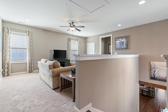 carpeted living room with ceiling fan