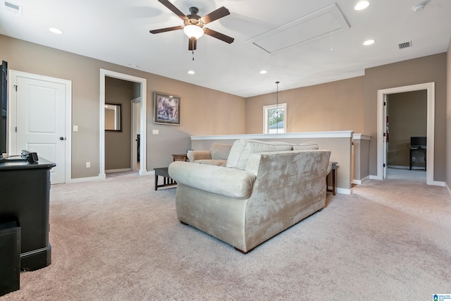 carpeted living room with ceiling fan