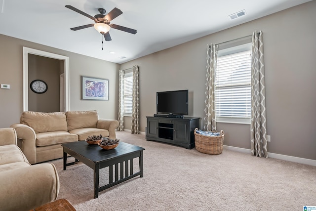 carpeted living room featuring ceiling fan